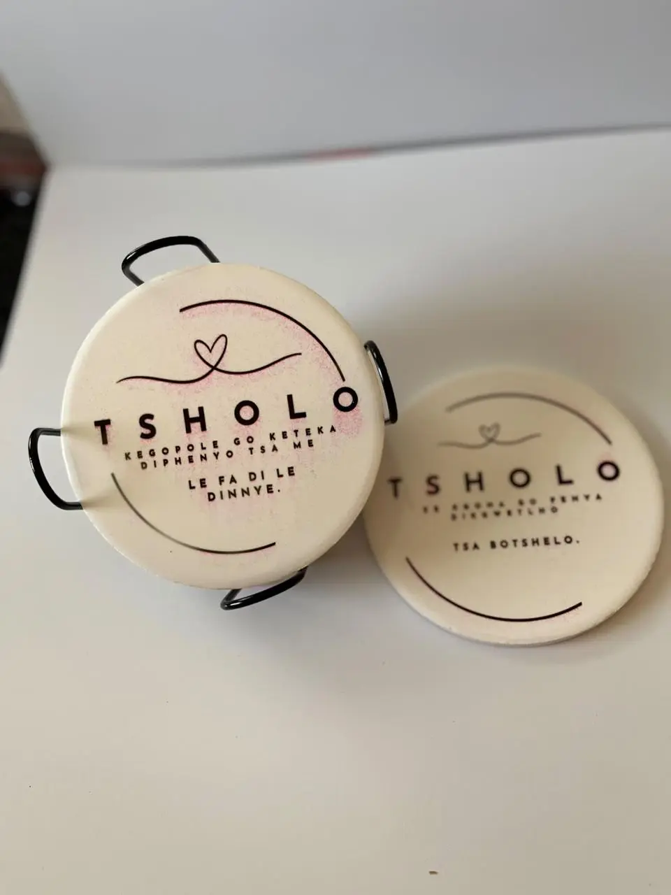 Cream round coasters with a personalised name and heart design